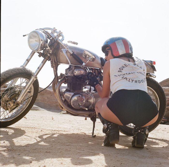 A playful frame from Girls on a motorcycle — online in Naples